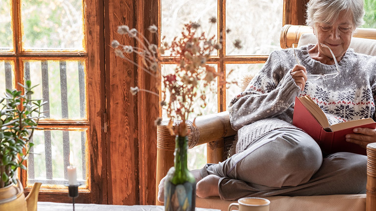 women reading book at home