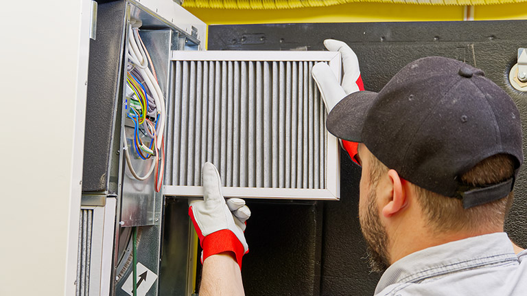 hvac tech replacing air filter