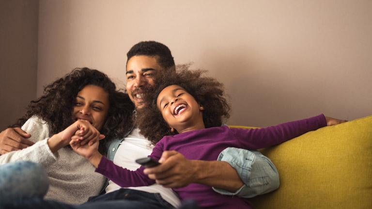 happy family watching a movie