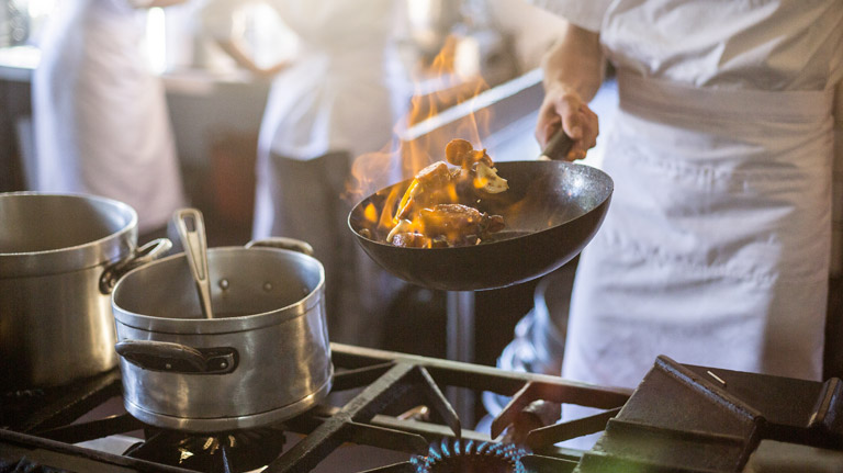 chef cooking on natural gas stove