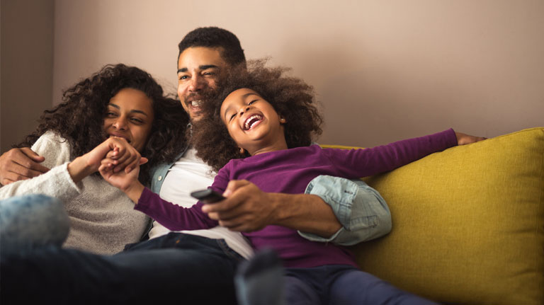 family watching movie on couch